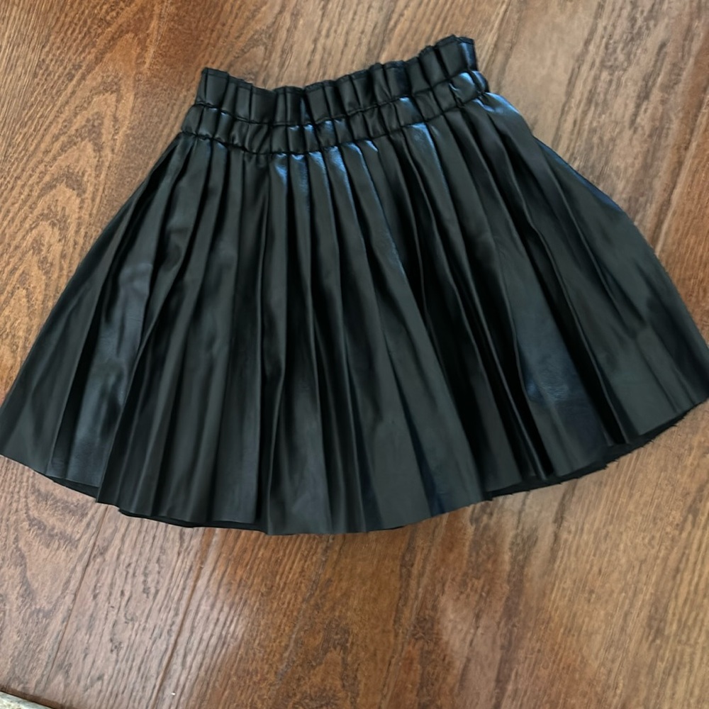 Size 130 pleather pleated skirt worn twice . Excellent condition